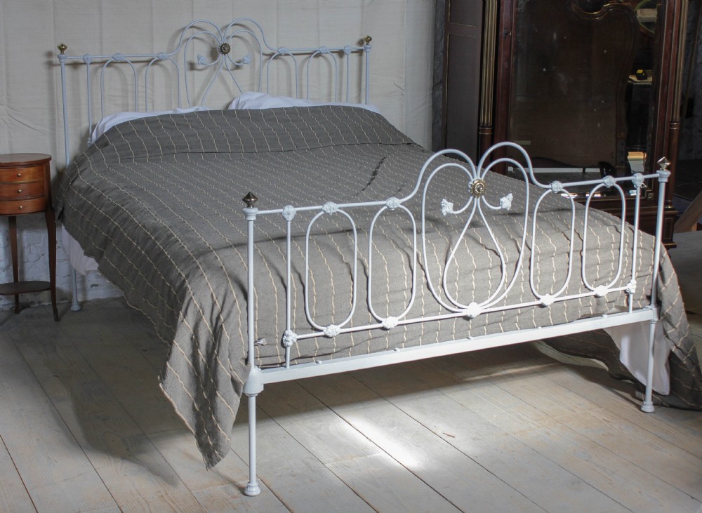 Pretty king size Victorian iron bedstead with little brass detail