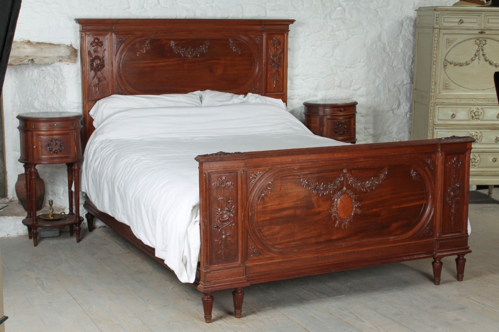 Beautiful carved walnut king size bed with pair of matching bedsides