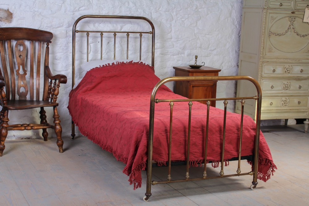 French antique aged brass single bed with castors