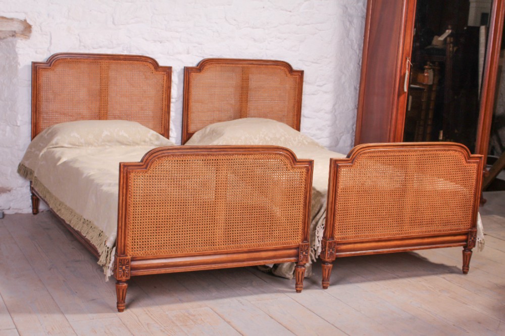 Pair of French caned beregere single beds