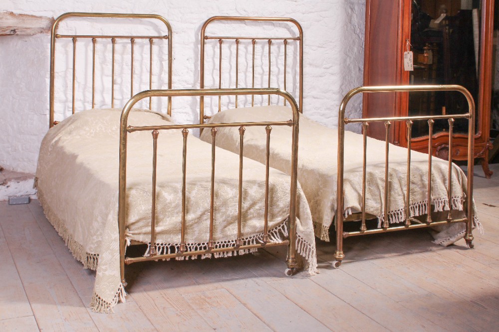 Pair of simple single French brass beds