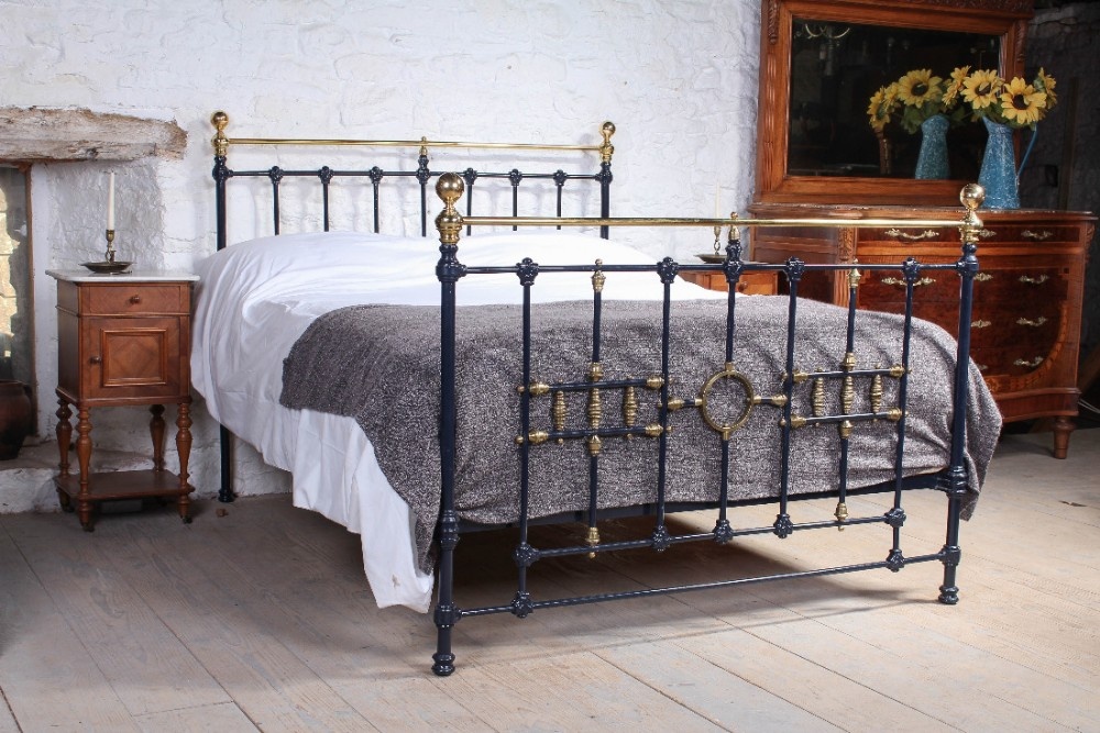 Classic Victorian blue and brass king size bed with ring and spindle detail