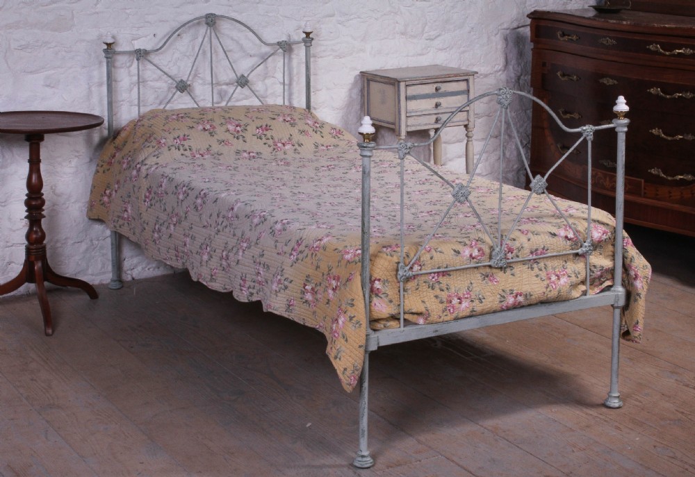 Pretty hand finished single iron bed with porcelain knobs