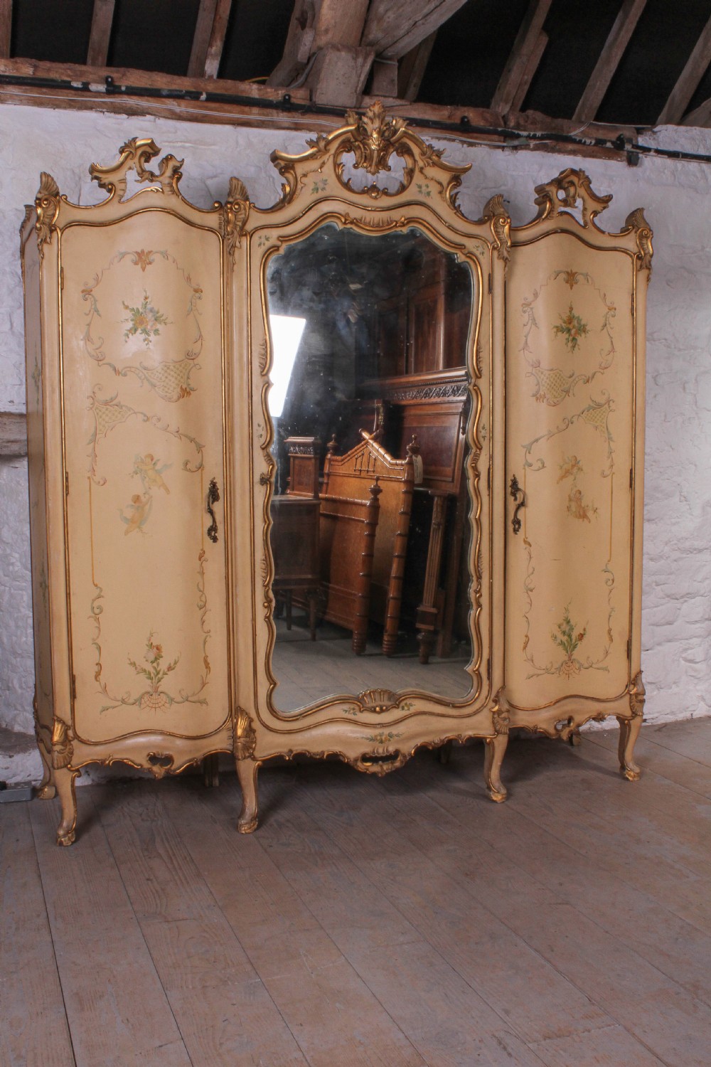 Flamboyant Italian three door painted and gilded wardrobe 