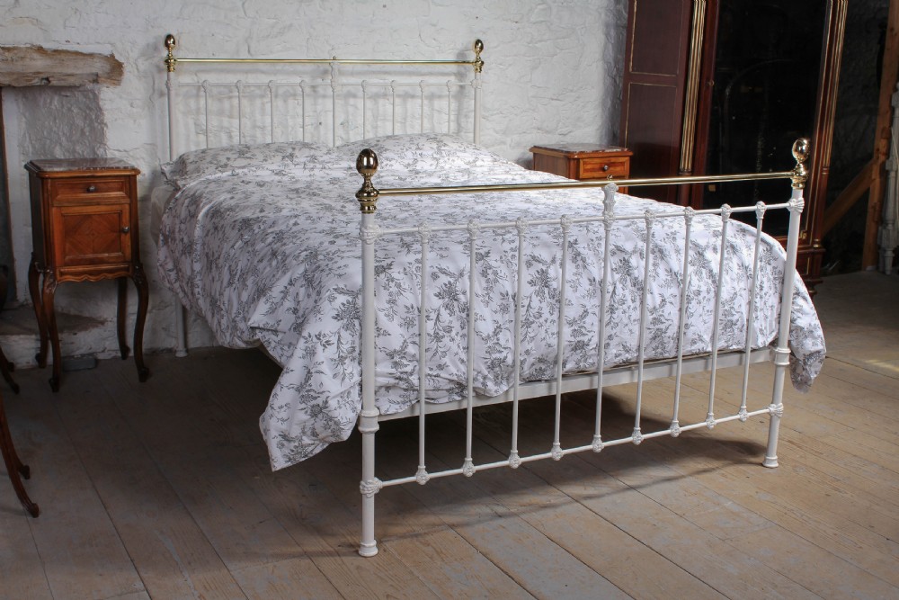 Classic Victorian aged white and brass kings size bed