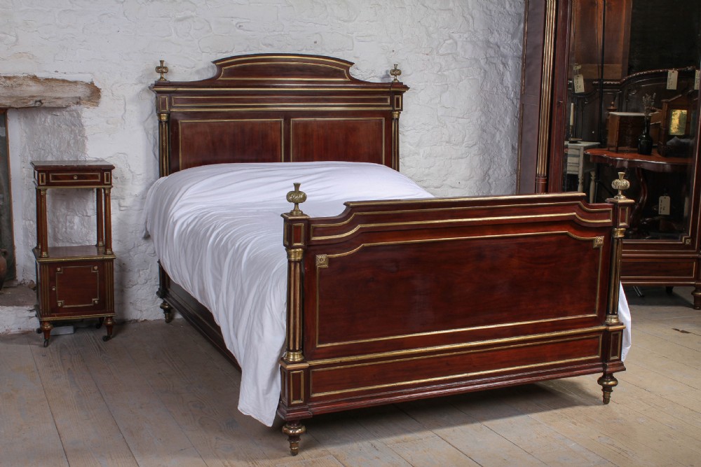 Handsome French Empire style mahogany with brass details double bed