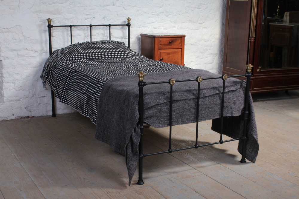Simple attractive Edwardian black and brass single bed
