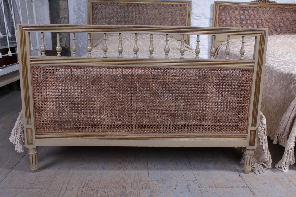 Pretty pair of French meter wide caned gilded beds View II