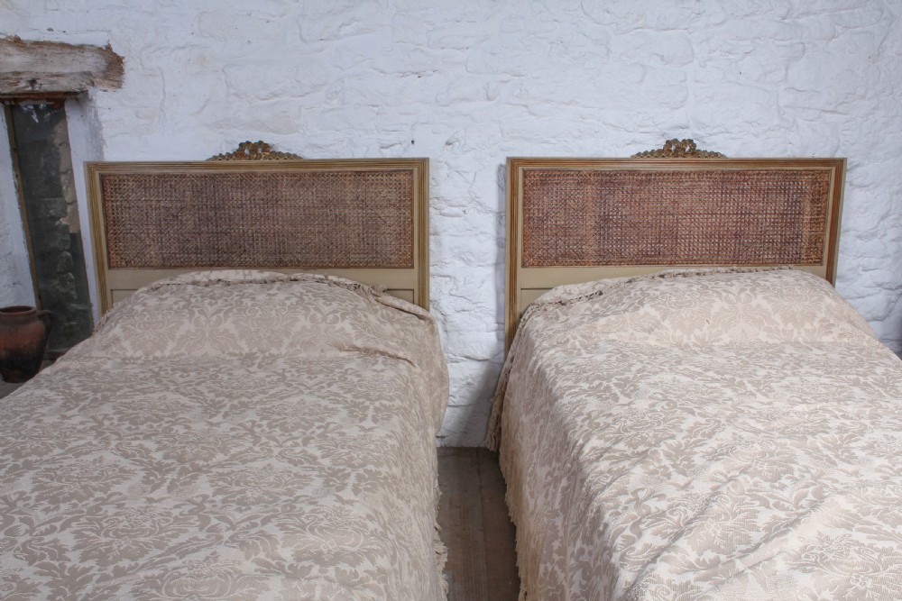 Pretty pair of French meter wide caned gilded beds View V