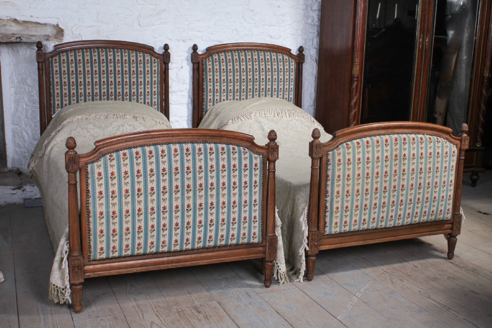 Pair of French carved oak upholstered single beds