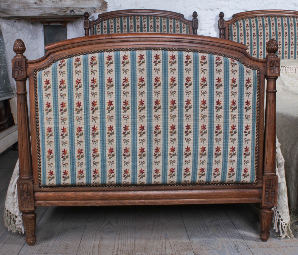Pair of French carved oak upholstered single beds View II