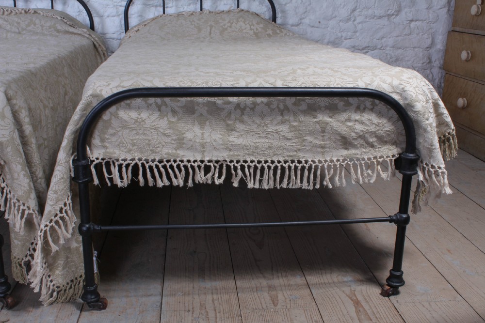 Almost pair of dorm style all iron Victorian single beds View VI