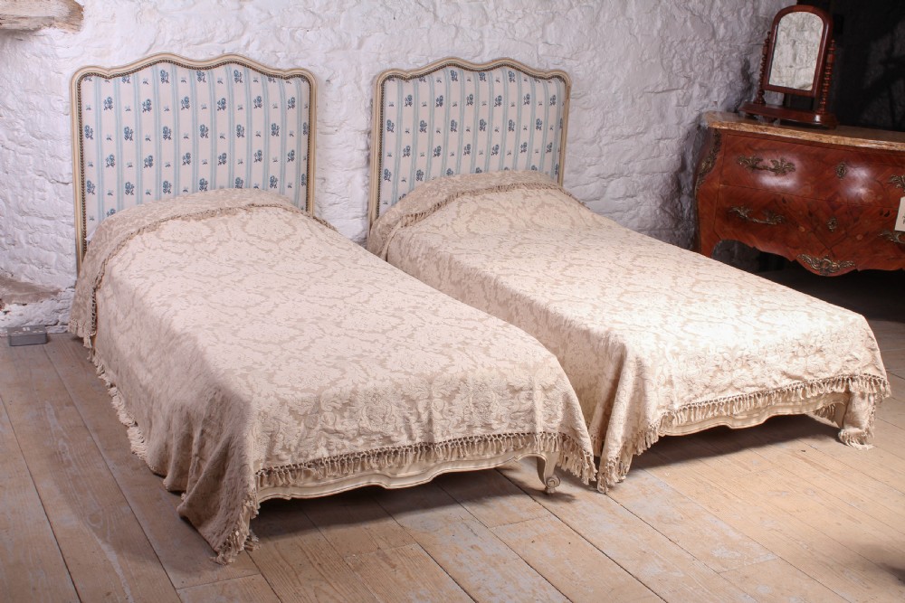 Pair of pretty French low end single upholstered beds