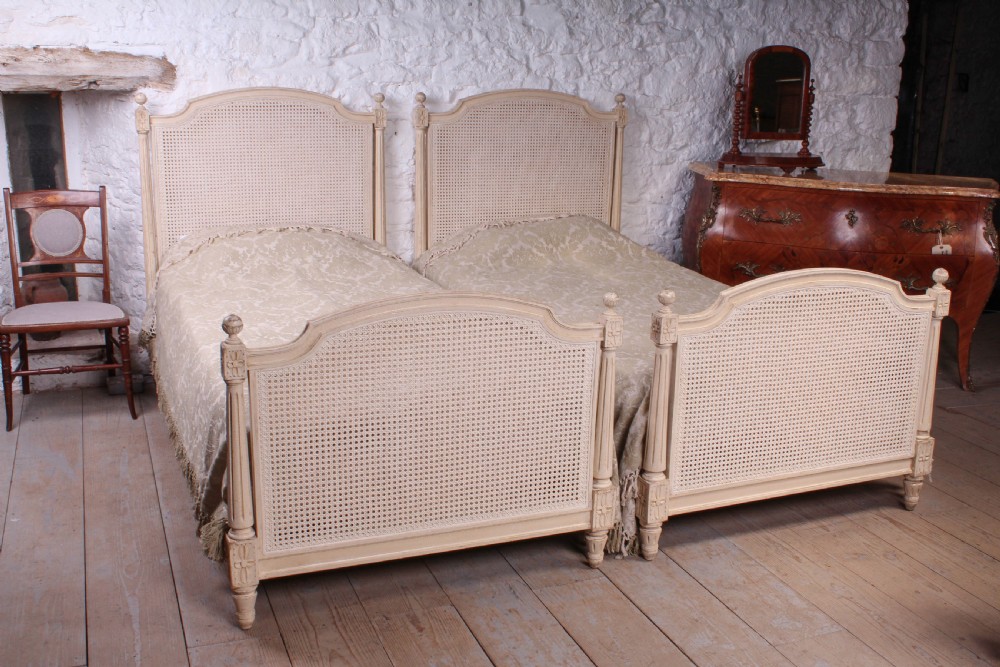 Pretty pair of French painted caned single beds