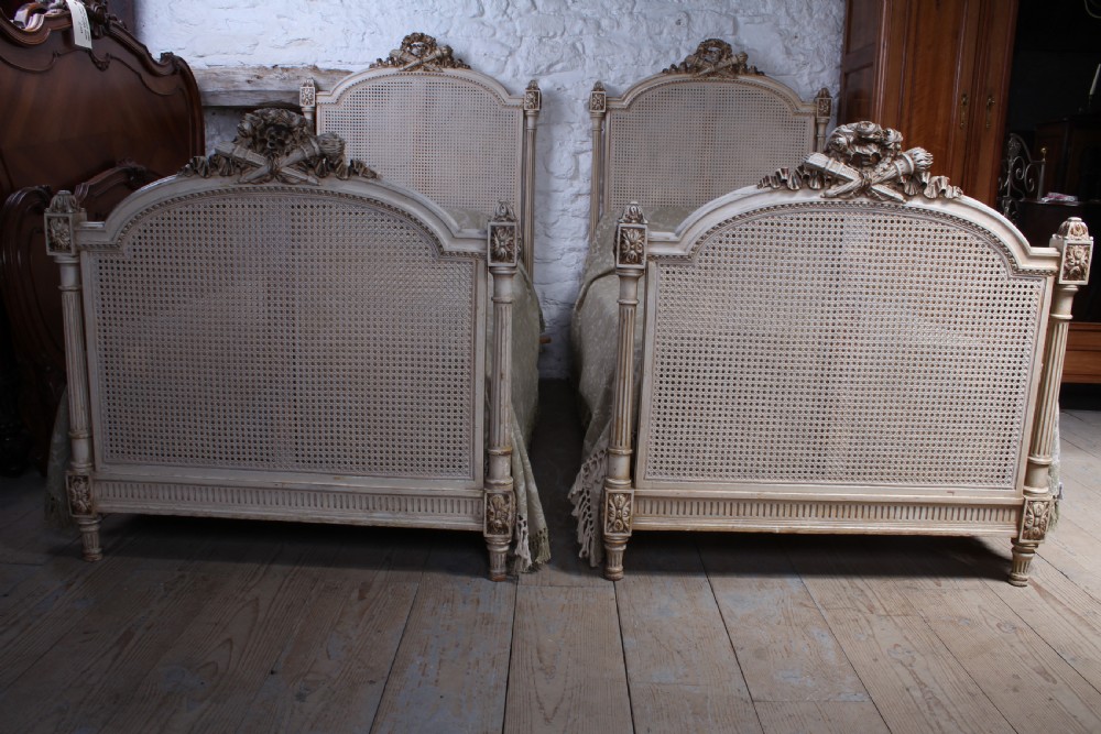 Striking pair of French Empire style caned single beds View V