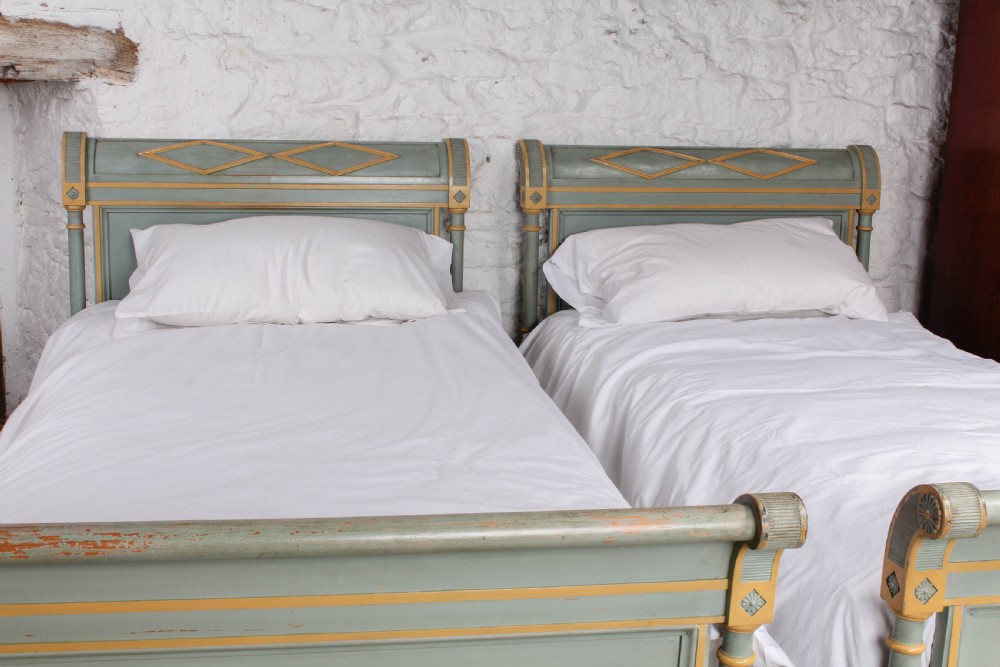 Matching pair of painted French Directoire single beds View II
