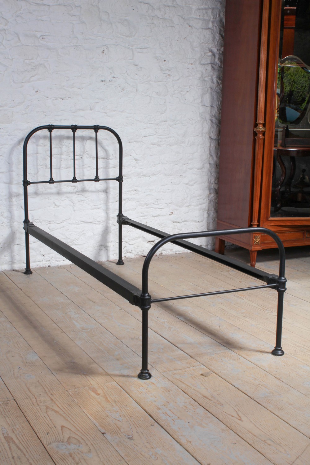 Small single utility iron bed