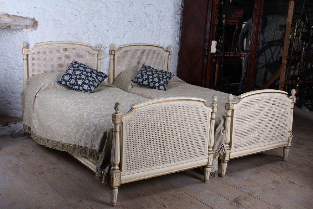 Pretty pair of French painted caned single beds
