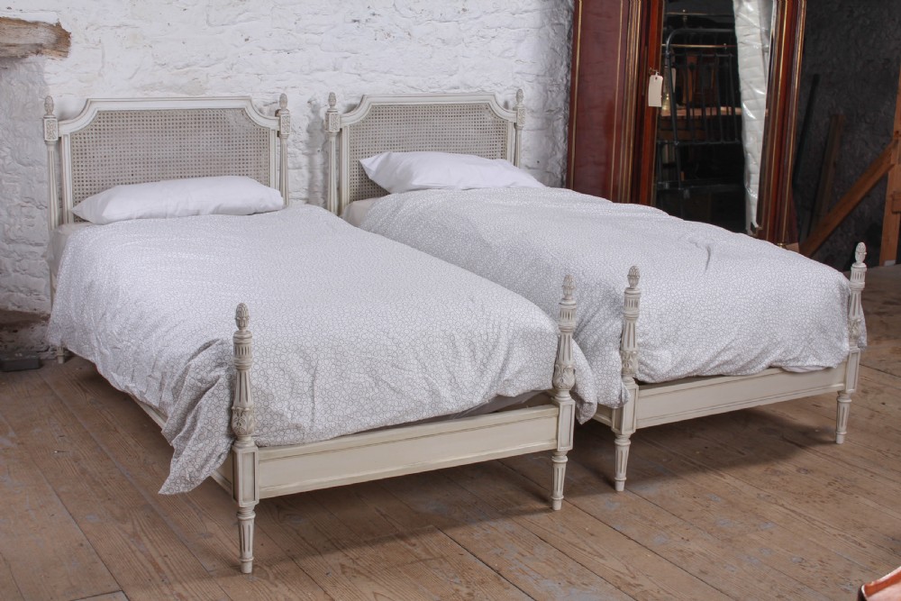 Pair of painted single caned low end bed