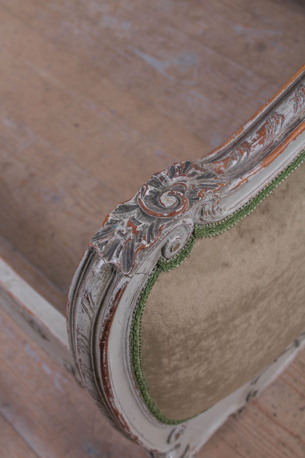 A pair of French Louis XV style single bed frames with carved grey painted timber and olive green velvet upholstered panels. View V