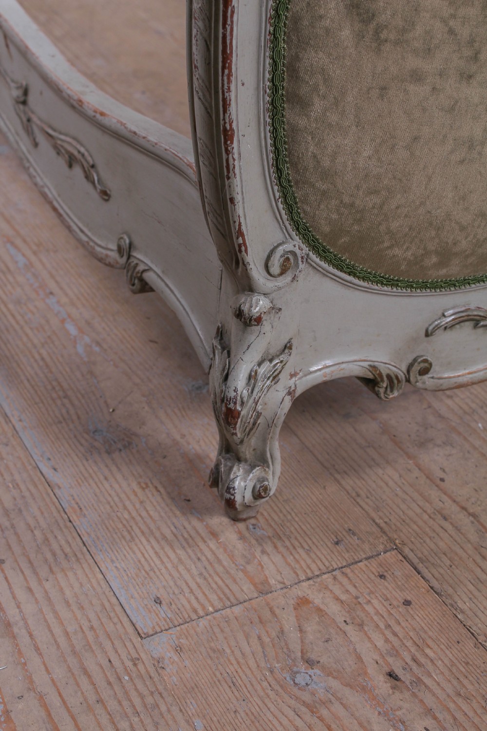 A pair of French Louis XV style single bed frames with carved grey painted timber and olive green velvet upholstered panels. View VI