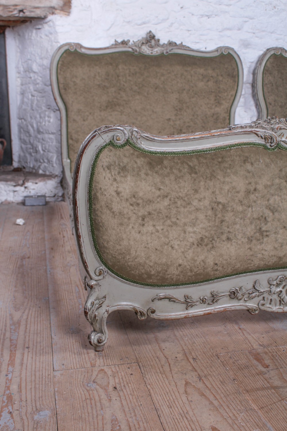 A pair of French Louis XV style single bed frames with carved grey painted timber and olive green velvet upholstered panels. View XI