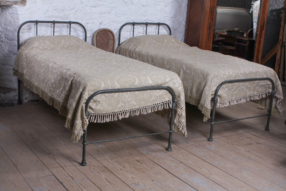 Lovely simple pair of utilitarian single iron beds View II