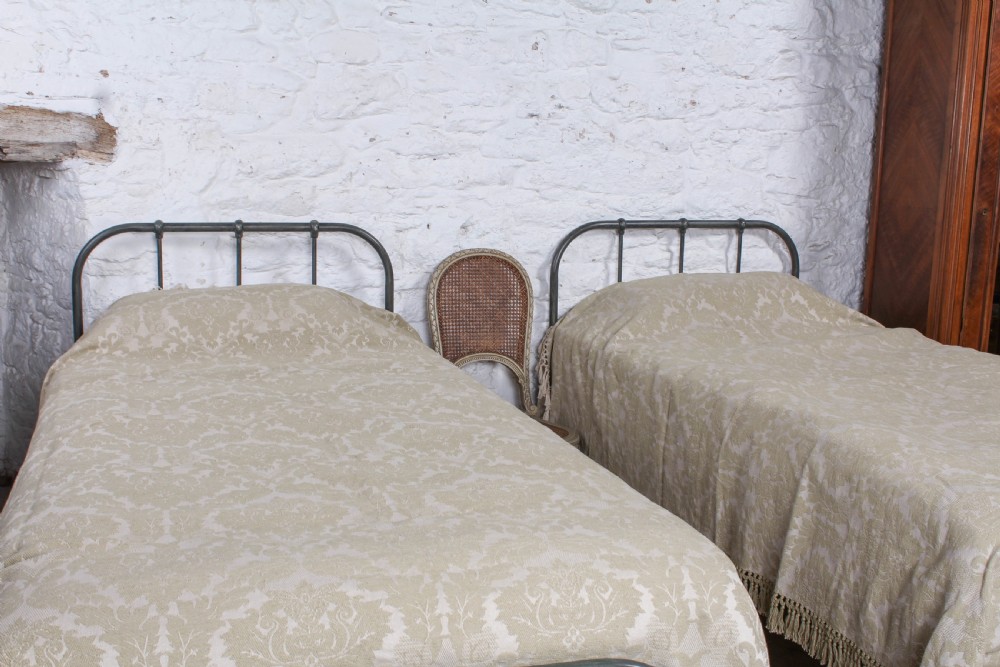 Lovely simple pair of utilitarian single iron beds View VIII