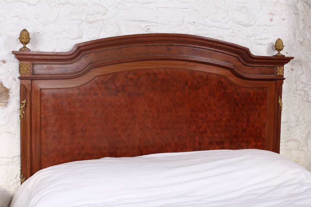 Magnificent mahogany and fruit wood parquetry king size bed with striking ormolu decoration. View III