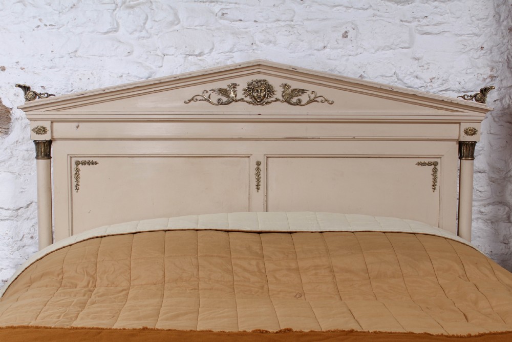 An off-white painted French king-size bedstead featuring gilt metal mounts, torch motifs, and carved claw feet. View II