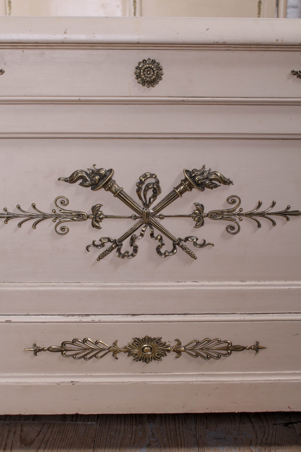 An off-white painted French king-size bedstead featuring gilt metal mounts, torch motifs, and carved claw feet. View VI