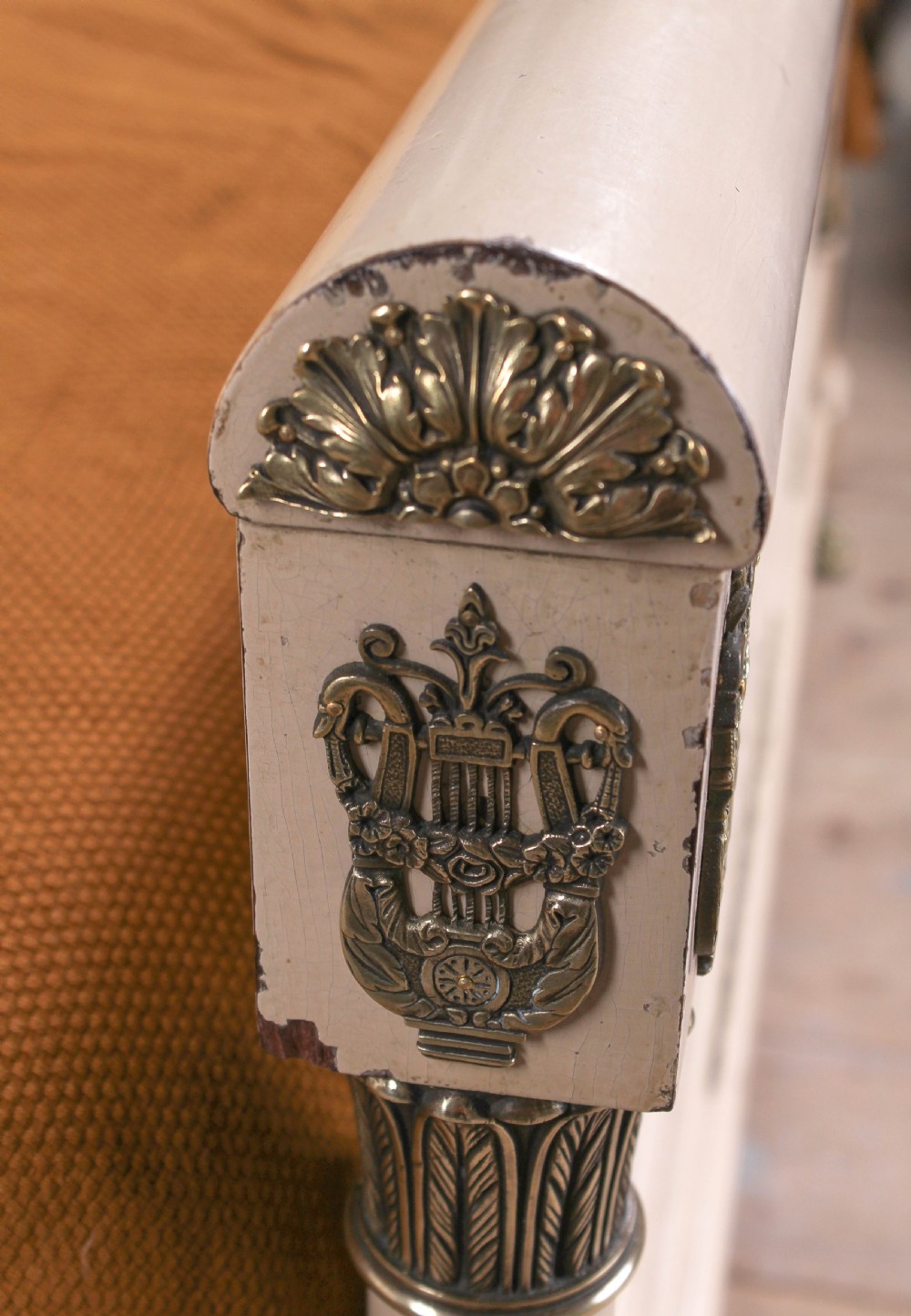 An off-white painted French king-size bedstead featuring gilt metal mounts, torch motifs, and carved claw feet. View VII