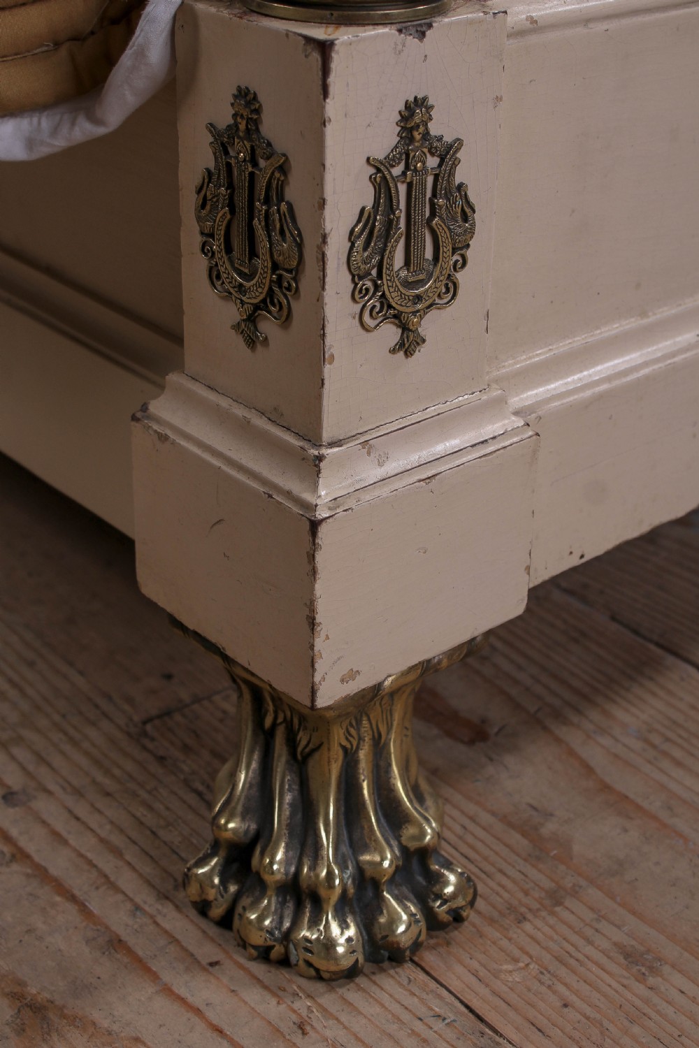 An off-white painted French king-size bedstead featuring gilt metal mounts, torch motifs, and carved claw feet. View X