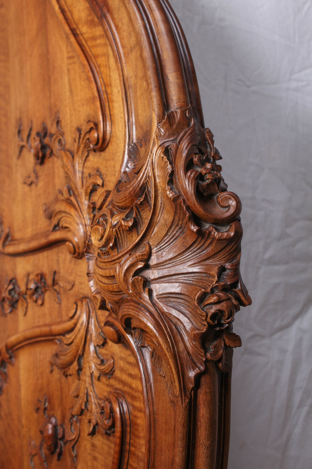 A French Louis XV style carved timber bedroom suite featuring a king-size bedstead, matching bedside cabinet, and three-door mirrored armoire. View V