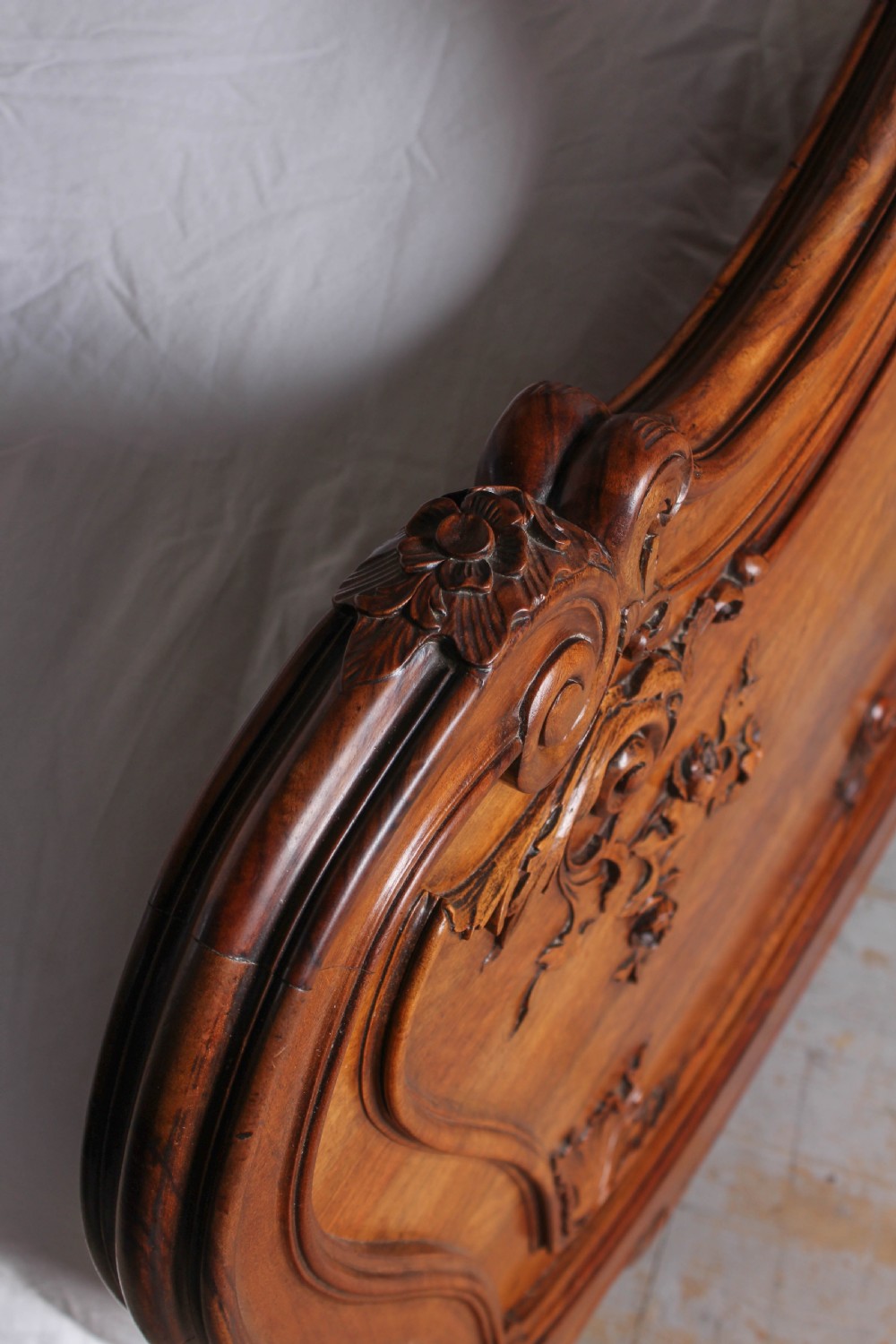 A French Louis XV style carved timber bedroom suite featuring a king-size bedstead, matching bedside cabinet, and three-door mirrored armoire. View VI