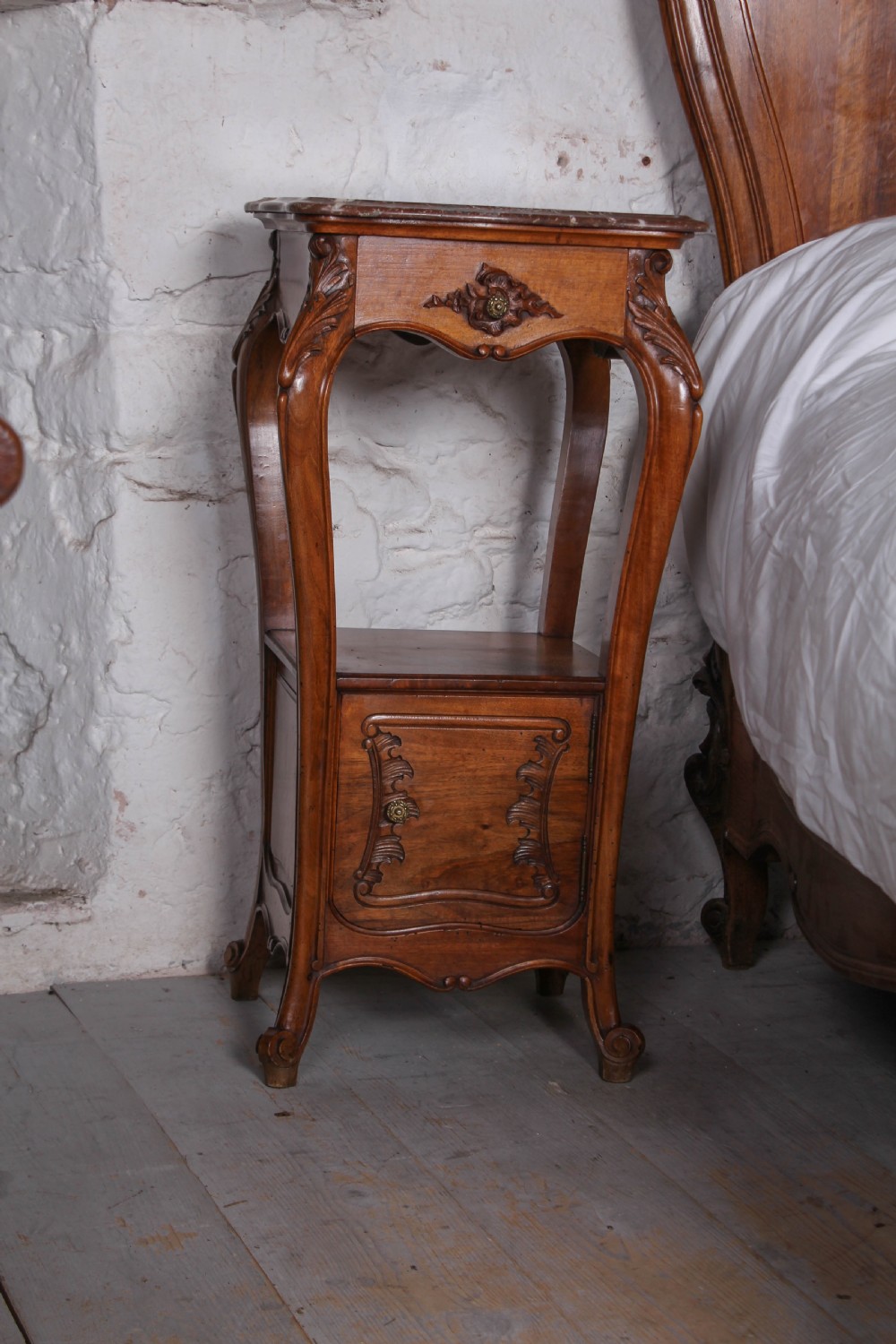 A French Louis XV style carved timber bedroom suite featuring a king-size bedstead, matching bedside cabinet, and three-door mirrored armoire. View XI