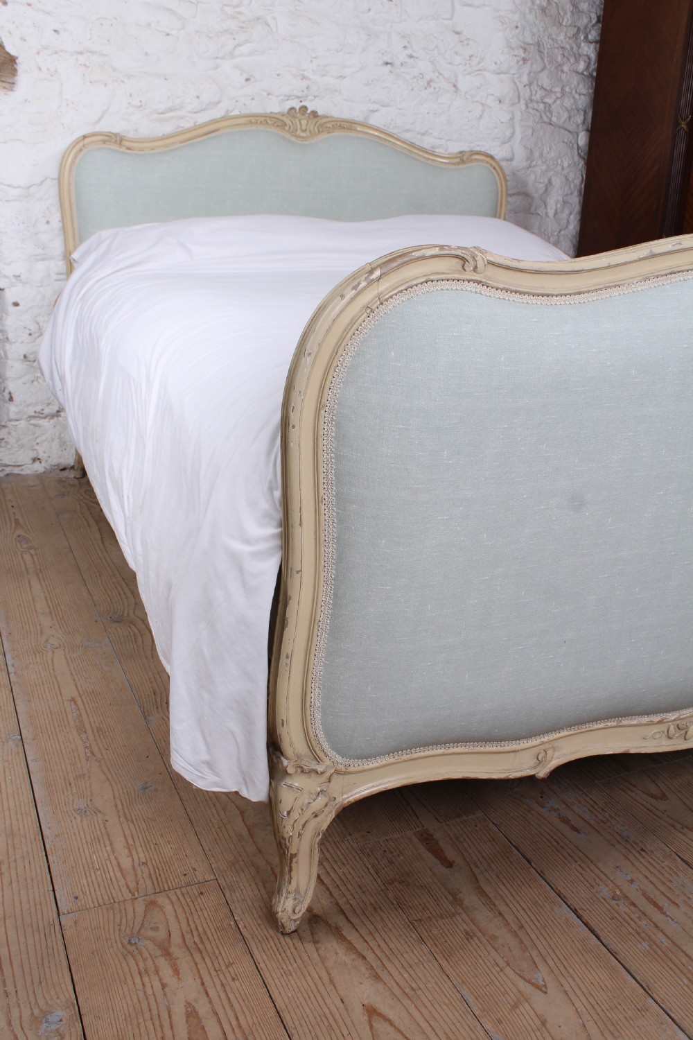 A Louis XV style king-size bed frame featuring a carved cream painted timber surround, upholstered headboard and footboard in pale blue fabric, resting on cabriole legs. View II