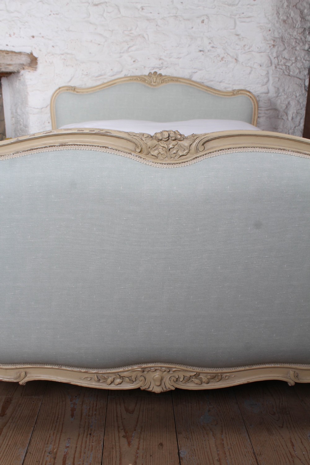 A Louis XV style king-size bed frame featuring a carved cream painted timber surround, upholstered headboard and footboard in pale blue fabric, resting on cabriole legs. View IV