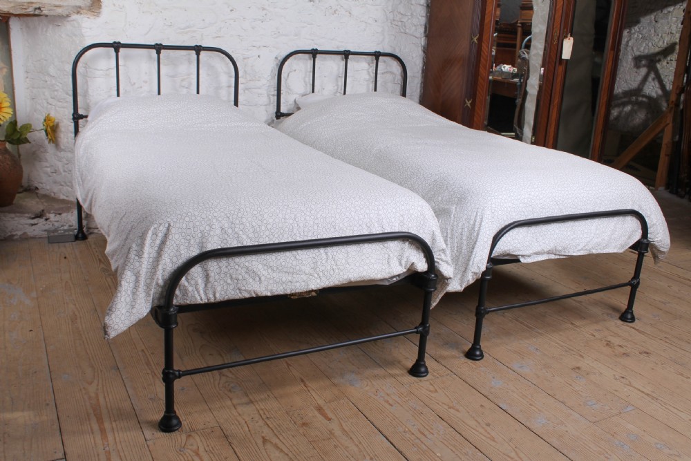 Lovely simple pair of Staples  utilitarian single iron beds (can be joined)