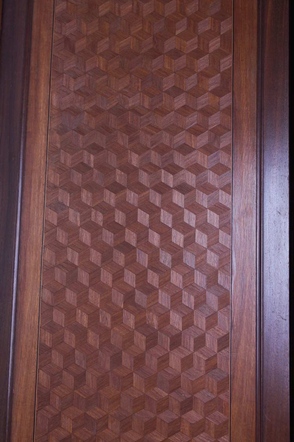 A tall French Louis XVI Revival warm brown wood armoire featuring arched twin mirrored doors, parquetry side panels, and decorative brass mounts. View V