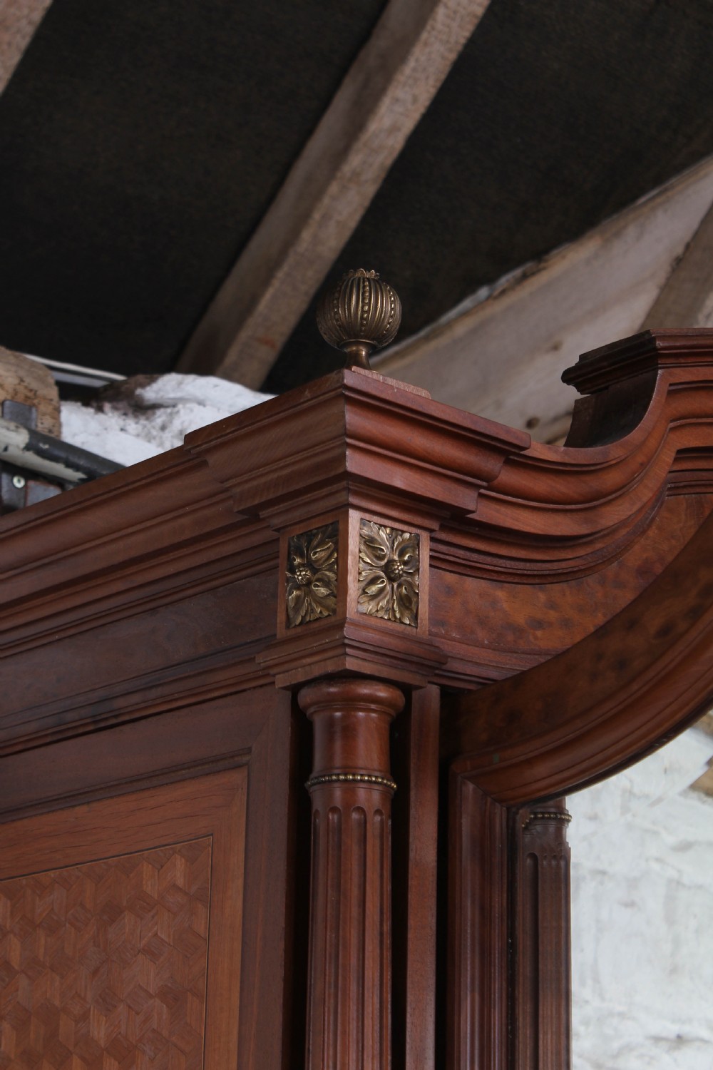 A tall French Louis XVI Revival warm brown wood armoire featuring arched twin mirrored doors, parquetry side panels, and decorative brass mounts. View VIII