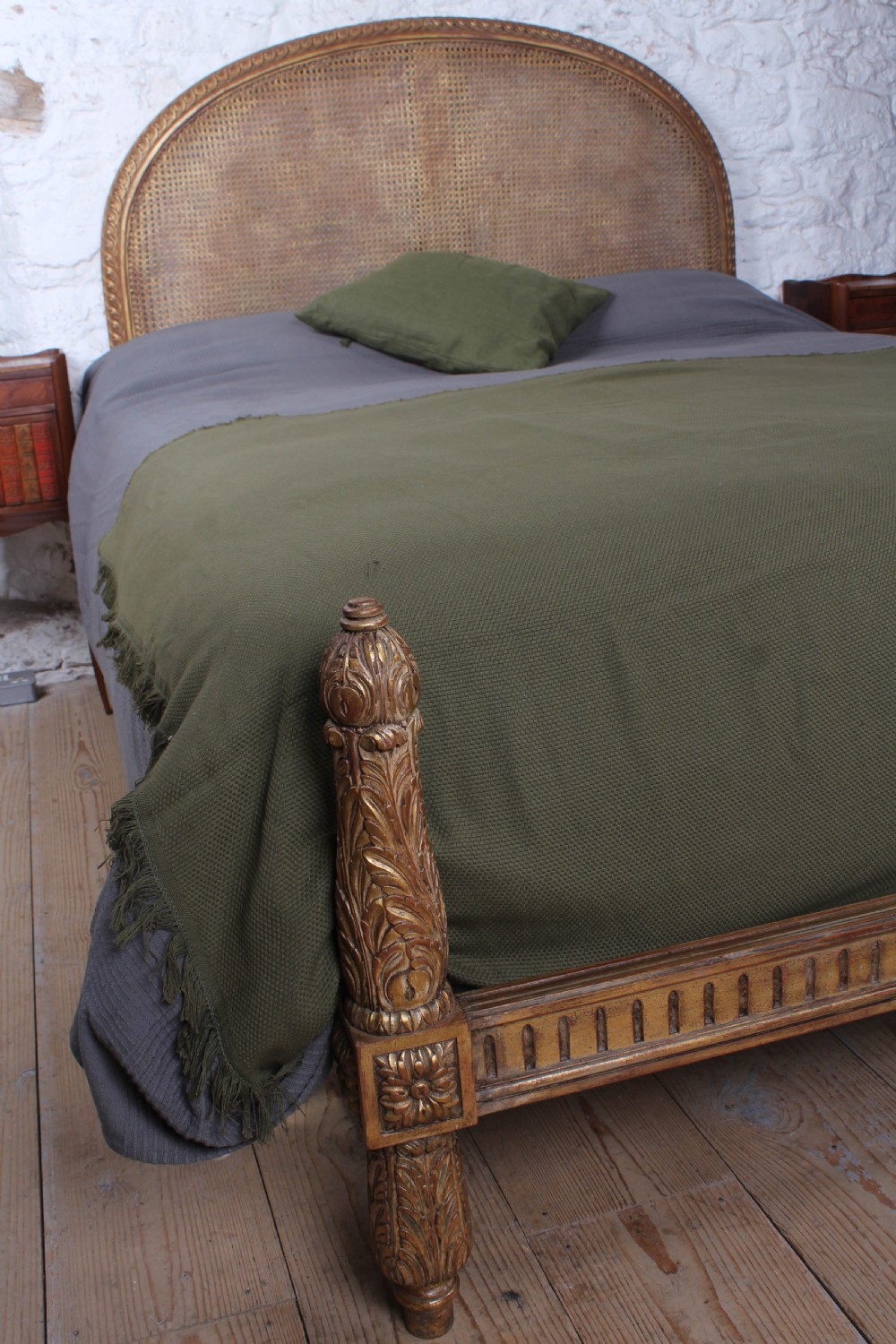 A French Neoclassical king-size bed featuring a carved giltwood frame with an arched caned headboard and detailed fluted posts. View III