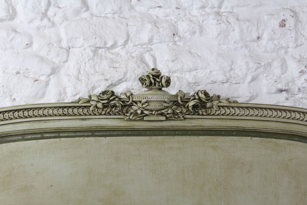 A French Louis XVI style king size bedstead in distressed sage green paint with carved fluted posts and decorative molding. View IV