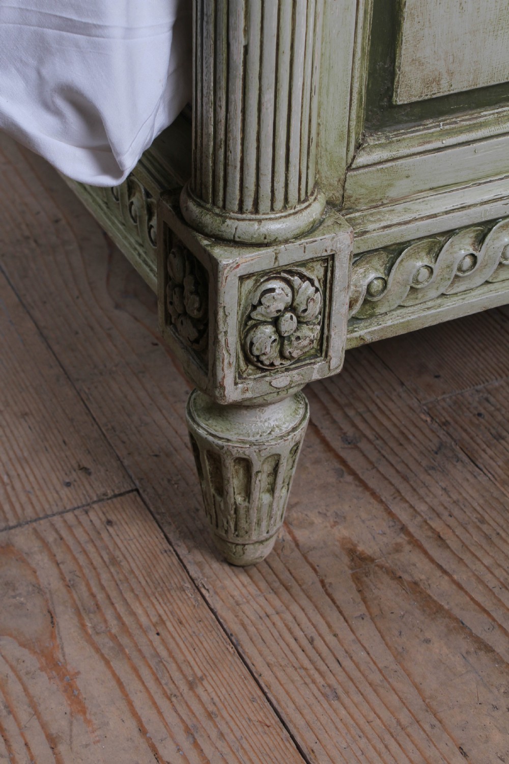 A French Louis XVI style king size bedstead in distressed sage green paint with carved fluted posts and decorative molding. View V