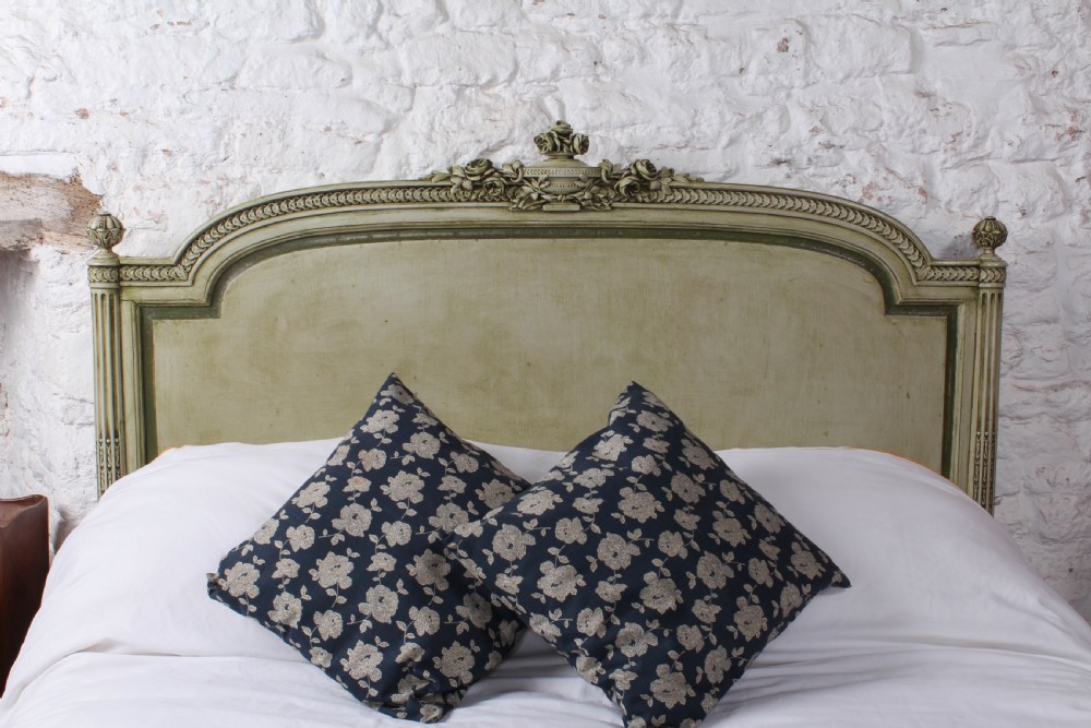 A French Louis XVI style king size bedstead in distressed sage green paint with carved fluted posts and decorative molding. View VIII