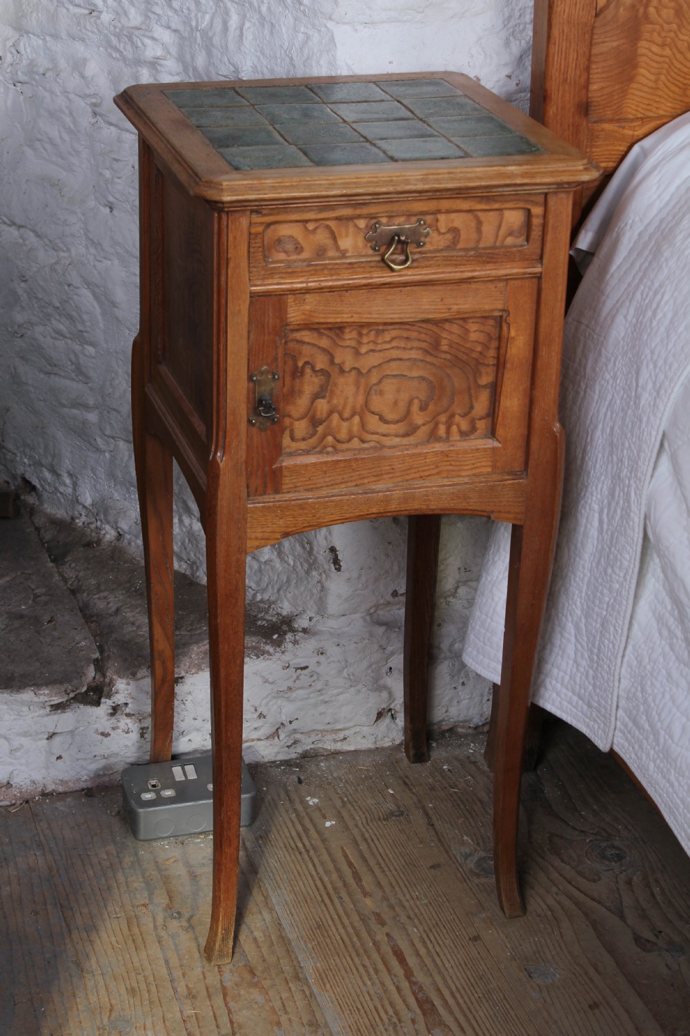 An Art Nouveau wooden bedroom suite featuring a curved double bedstead, matching dressing table with mirror, nightstand, and leather-upholstered side chairs. View VIII