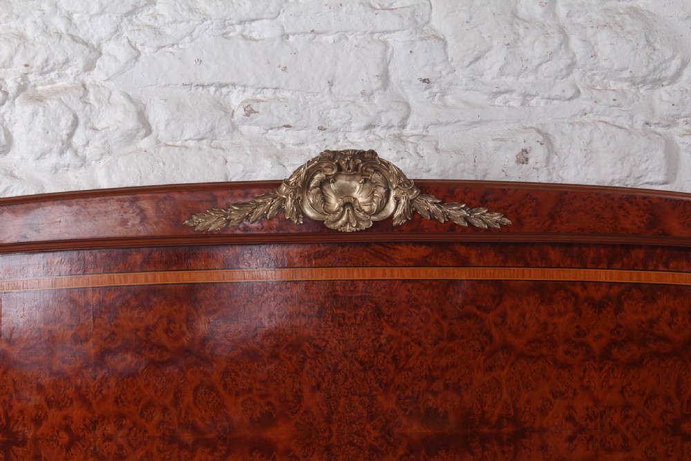 A French style kingsize bed frame in warm brown burr mahogany with fruitwood inlay borders and gilt metal corner mounts. View VI