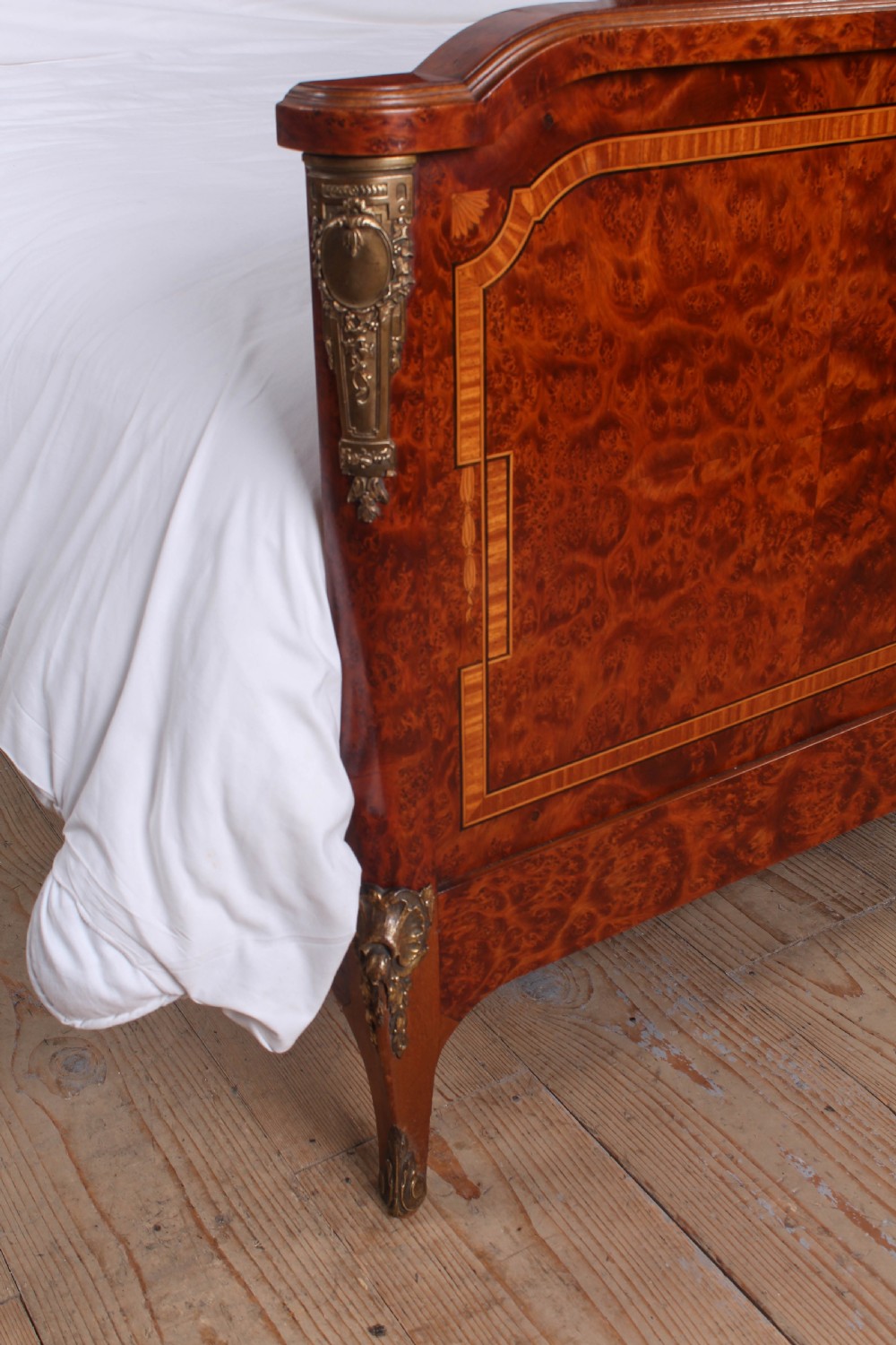 A French style kingsize bed frame in warm brown burr mahogany with fruitwood inlay borders and gilt metal corner mounts. View VII
