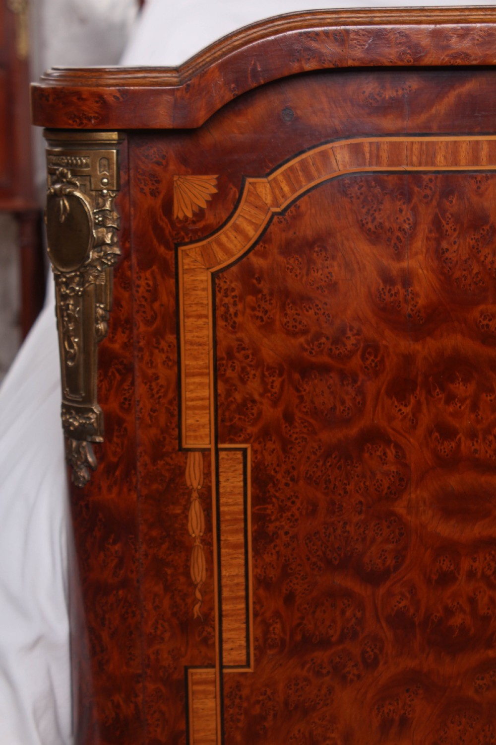 A French style kingsize bed frame in warm brown burr mahogany with fruitwood inlay borders and gilt metal corner mounts. View IX