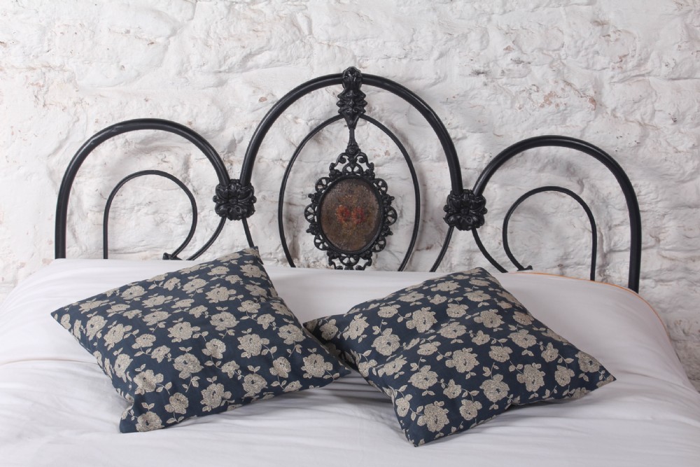 A Victorian black cast and wrought iron double bed frame featuring a three-hoop headboard and footboard with central decorative medallions. View II